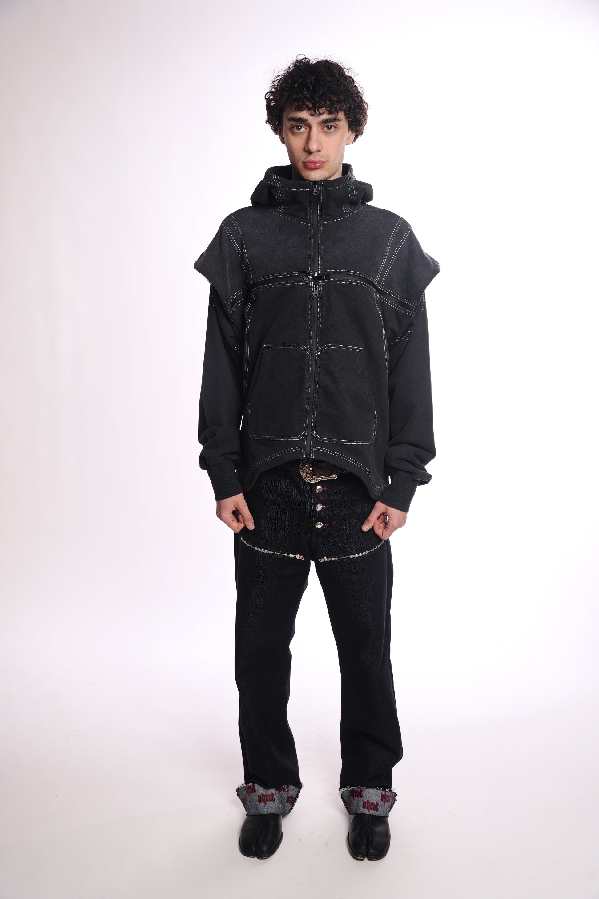 Person wearing a black hoodie  OGP ZIP UP With quad zipper and pants on a white background
