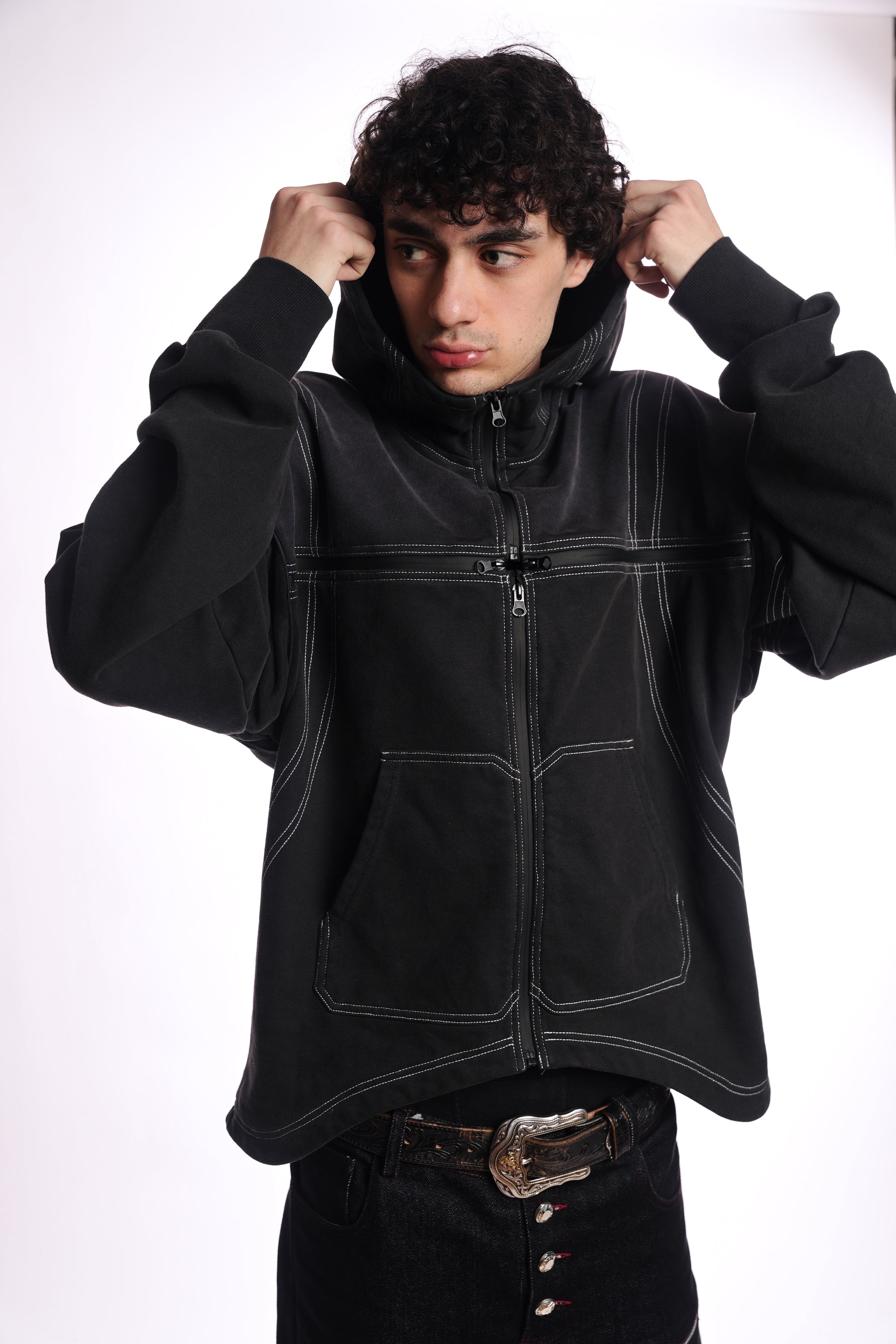 Person wearing a black jacket with a white background