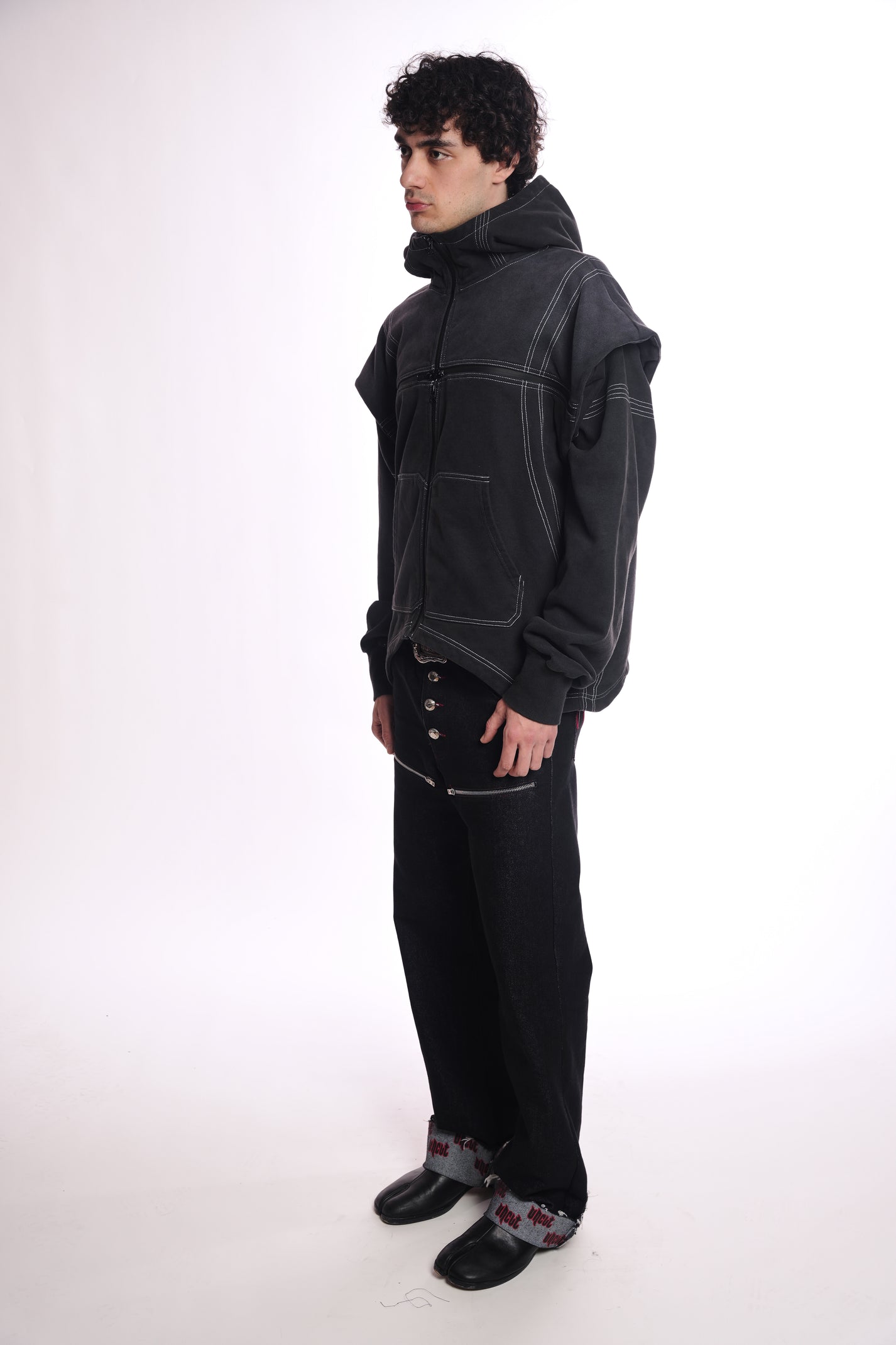 Person wearing the Ogp zip up outfit with a high collar on a white background