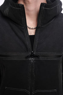 Close-up of a black jacket with a  quad zipper, worn by a person.