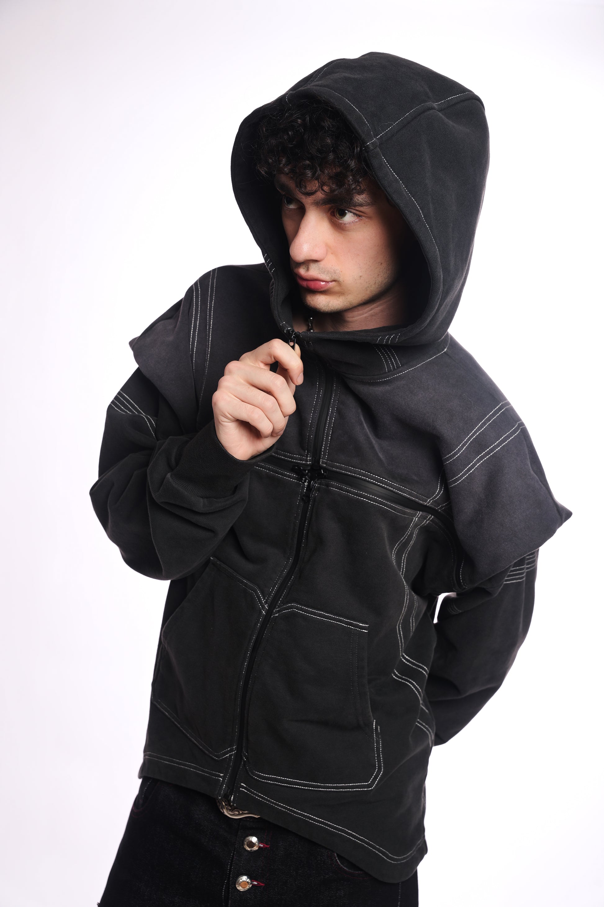 Person wearing a black &amp; Grey zip up with a quad zipper on a white background