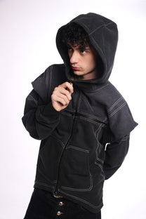 Person wearing a black &amp; Grey zip up with a quad zipper on a white background