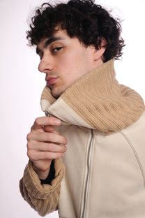 Man wearing a beige jacket with a knitted collar on a white background