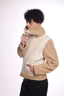 Person wearing a beige and white jacket on a white background